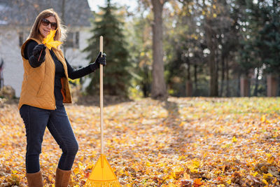 Full length of woman standing in forest