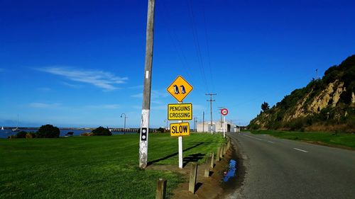 Road sign against blue sky