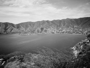 Scenic view of lake and mountains against sky