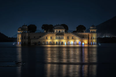 Reflection of building in water at night