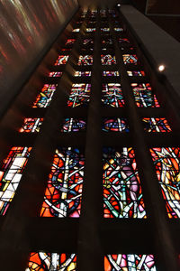 Low angle view of illuminated glass window in building