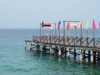 Pier over sea against clear sky