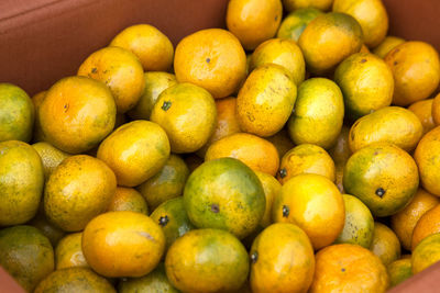 High angle view of tangerines in box at market