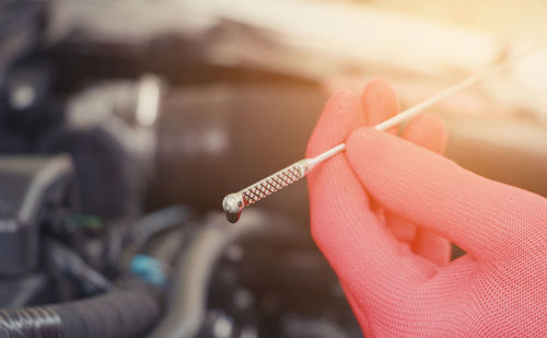 Close-up of hand holding cigarette