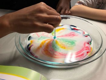 Midsection of person holding ice cream in plate