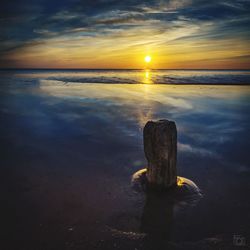 Scenic view of sea against sky at sunset