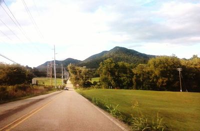 Empty road with mountains in background