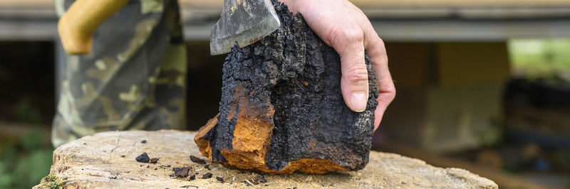 Midsection of person working on wood