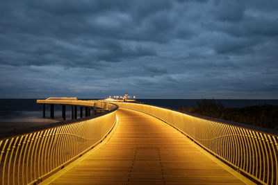 View of bridge over sea against cloudy sky