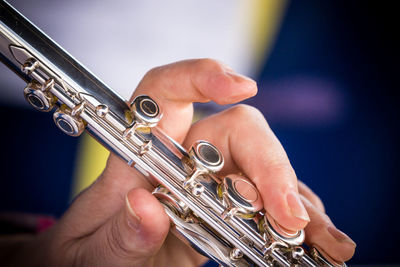 Close-up of hands playing musical instrument