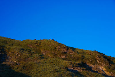 Scenic view of mountains against clear blue sky