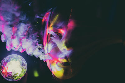 Close-up of woman exhaling smoke