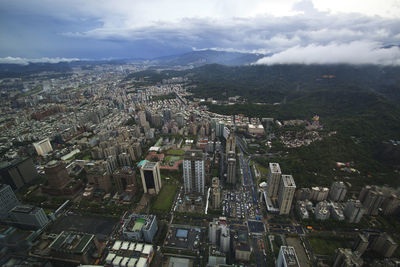 High angle view of buildings against cloudy sky