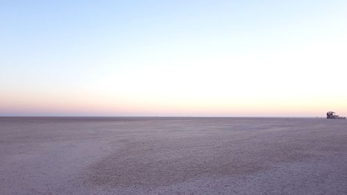 Scenic view of sea against clear sky during sunset