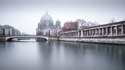 View of berlin cathedral by footbridge against sky