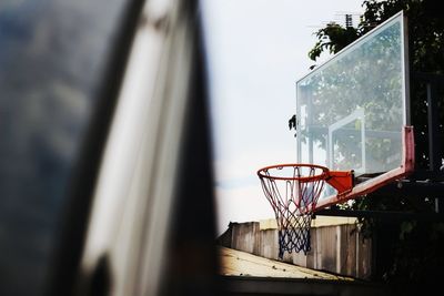 Close-up of basketball hoop seen through window
