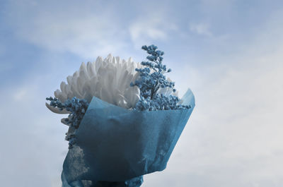 Close-up of ice cream against blue sky