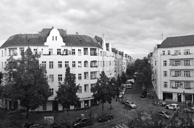 Buildings in city against cloudy sky