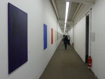 Rear view of woman walking in corridor of building