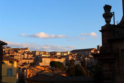 Buildings in city against blue sky