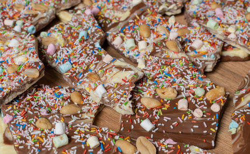 White and brown chocolate in preparation for broken chocolate topped with sugar sprinkles