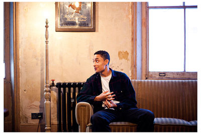 Young man using phone while sitting on chair