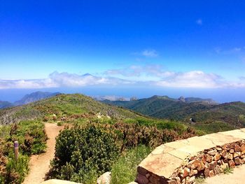 Scenic view of landscape against blue sky