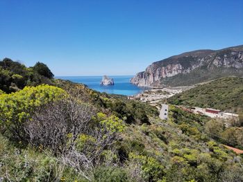 Panoramic view of sea against clear blue sky