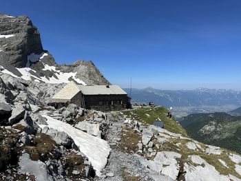 Scenic view of mountains against clear blue sky