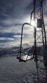 Ski lift hanging on snow covered landscape