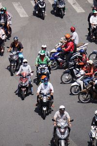 High angle view of people on motorcycles in city