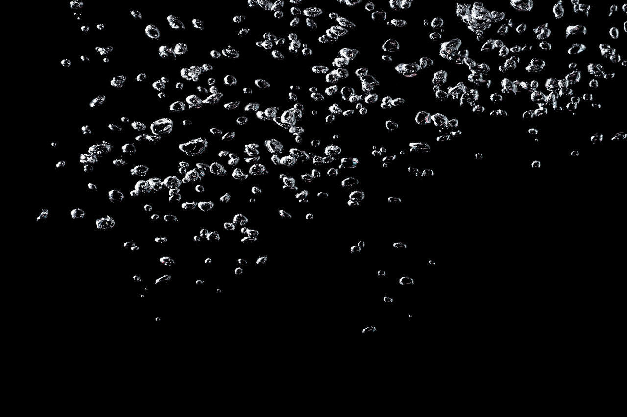 LOW ANGLE VIEW OF RAINDROPS ON WATER