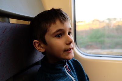 Close-up of boy sitting in train