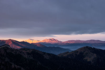 Scenic view of mountains against sky at sunset