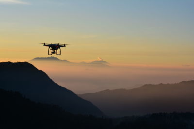 Scenic view of mountains against sky at sunset