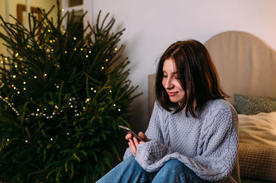 Beautiful young woman at home for christmas with gifts