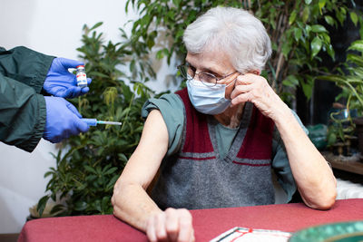 Senior woman unhappy about receiving the vaccine