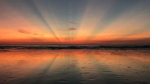 Scenic view of beach against sky during sunset