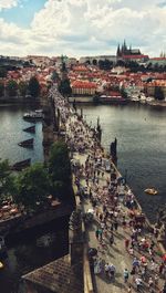 High angle view of city by river against sky