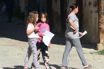 Full length of woman standing against the wall