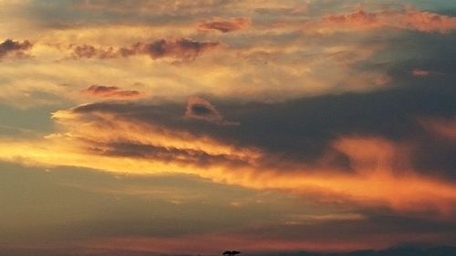 Low angle view of cloudy sky at sunset