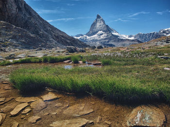 Scenic view of landscape and mountains against sky