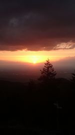 Scenic view of silhouette landscape against sky at sunset