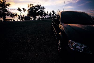 Car on road at sunset
