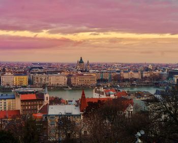 High angle view of buildings against cloudy sky during sunset