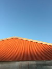 High section of built structure against clear blue sky