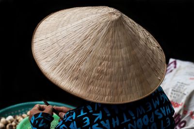 Close-up of person holding hat