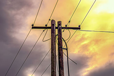 Low angle view of electricity pylon against sky