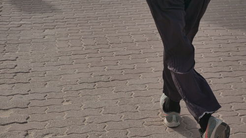 Low section of man walking on street