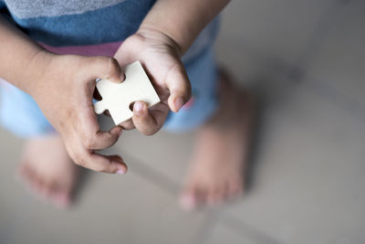 High angle view of baby holding hands